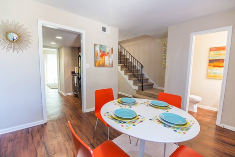 a dining area with a table and chairs